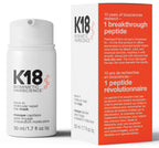 K18 hair care product bottle and packaging on a gray background