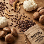Mushrooms, coffee beans, and a Mornis Organic Mushroom Coffee bag on a wooden surface.